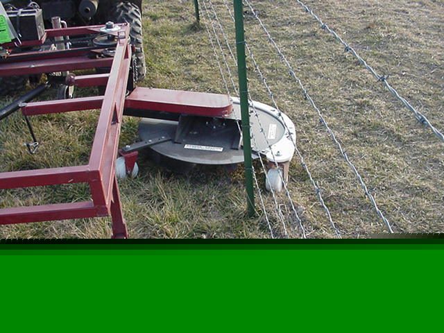 Fence runner mower mows under fences around posts